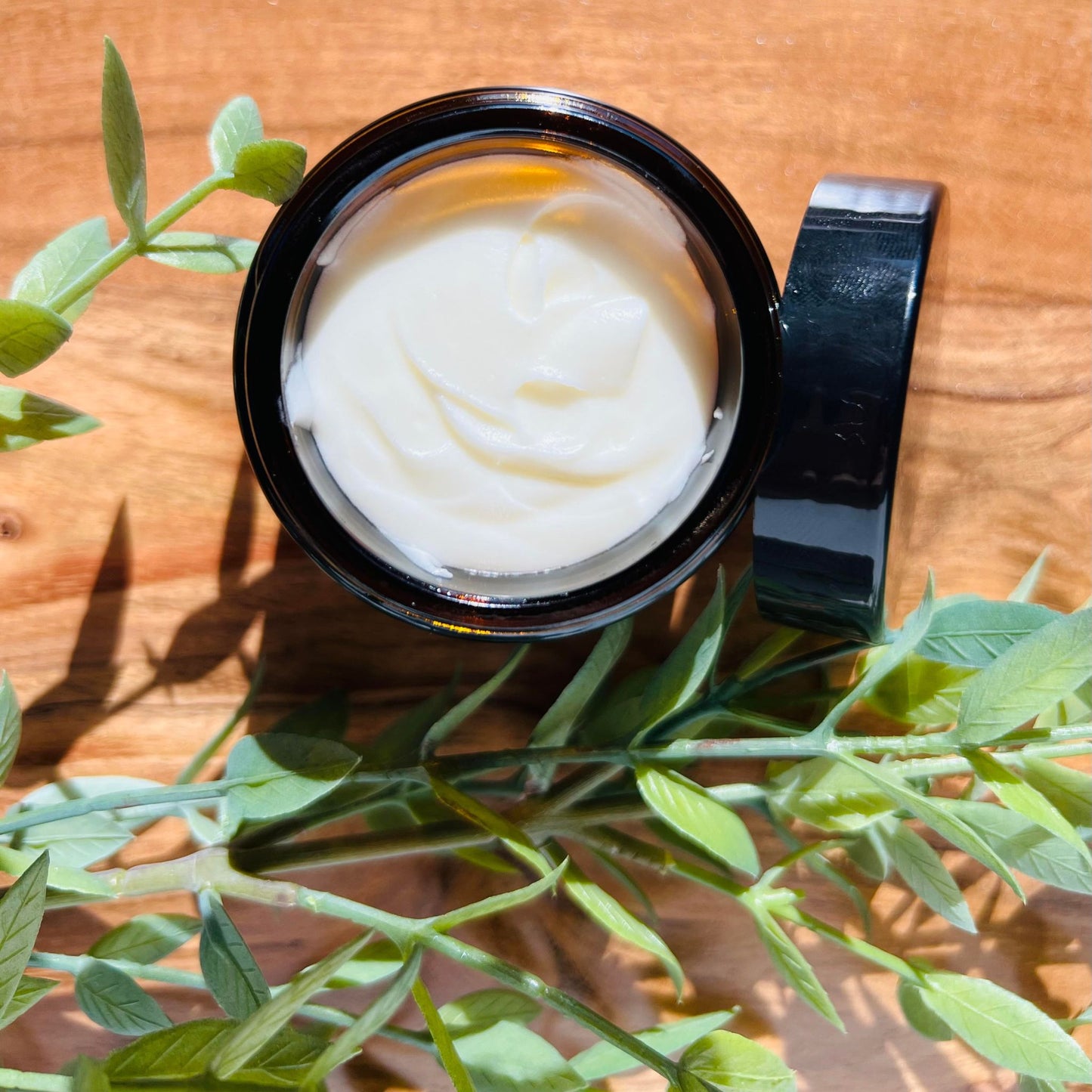 Jar of tallow whip from above with greenery