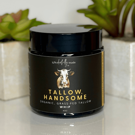 Jar of 'Tallow Handsome' organic, grass-fed tallow whip on a surface with plants in the background