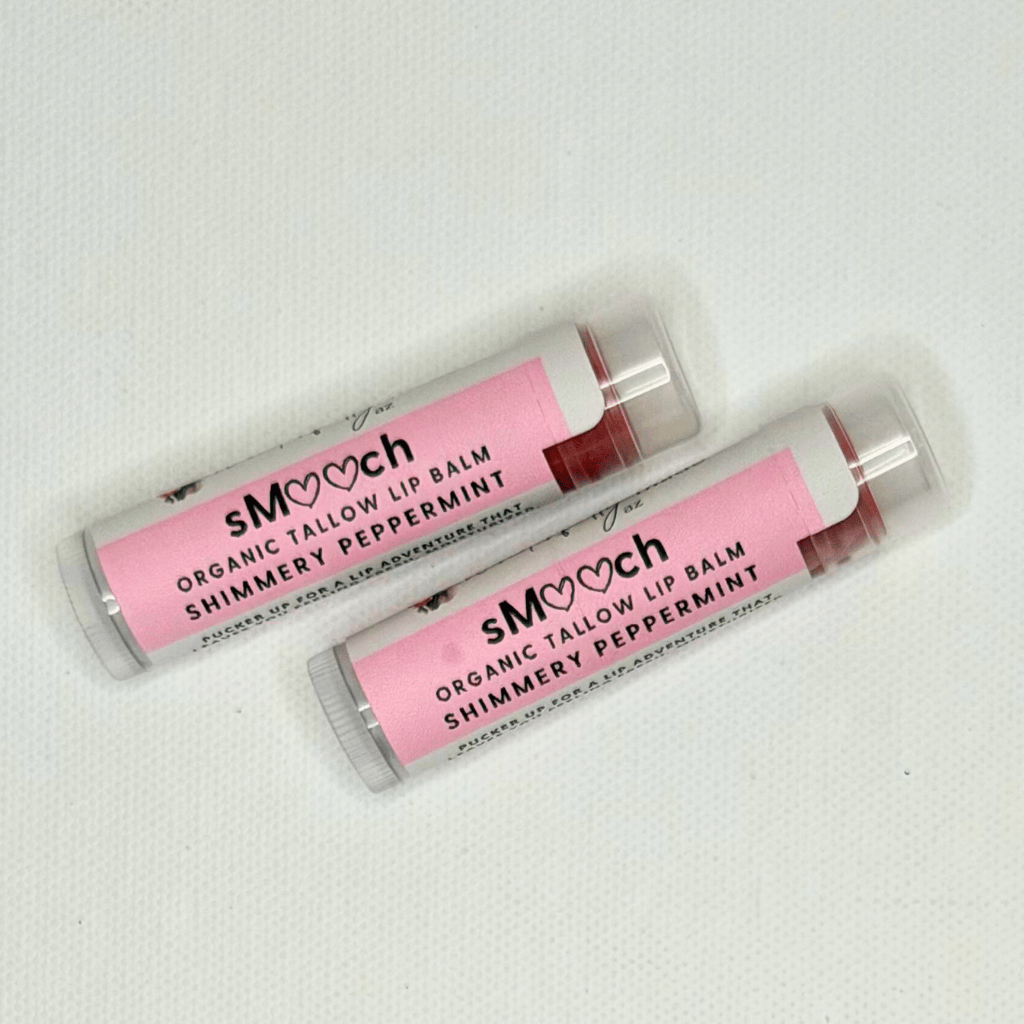 Two organic tallow lip balms with pink packaging on a white background